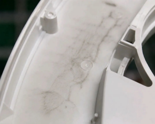 Cold slug and internal dark spot defects in injection molded plastic parts